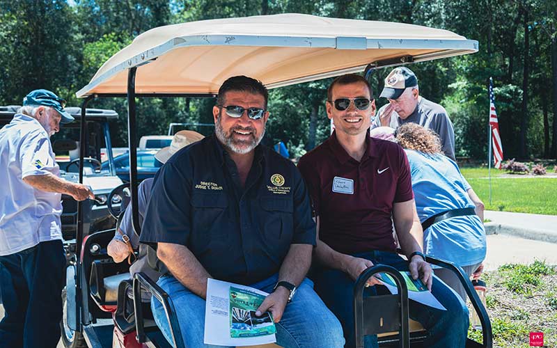 Two men on a golf cart