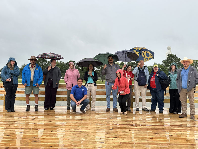 Group of people standing on a dock in the rain