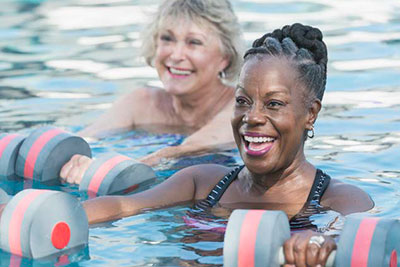 Seniors performing water exercises in a swimming pool