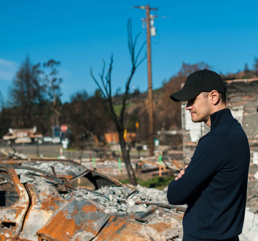 Person stands looking over a pile of debris
