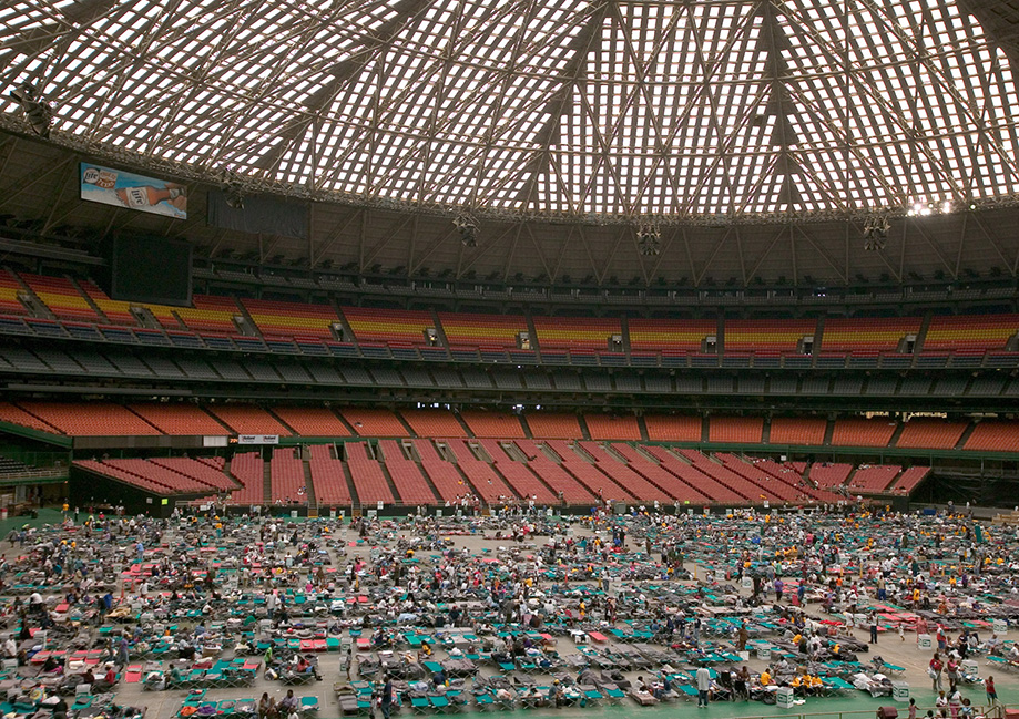 Hurricane Katrina survivors from New Orleans arrive by bus at a Red Cross shelter in the Houston Astrodome